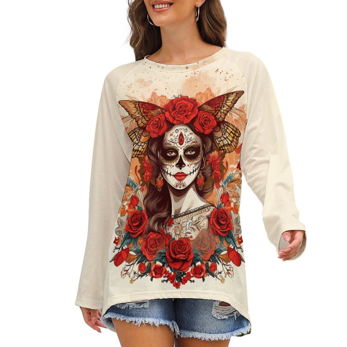 Woman wearing a cream-colored sweatshirt with a colorful graphic design of a woman with flowers and butterflies.