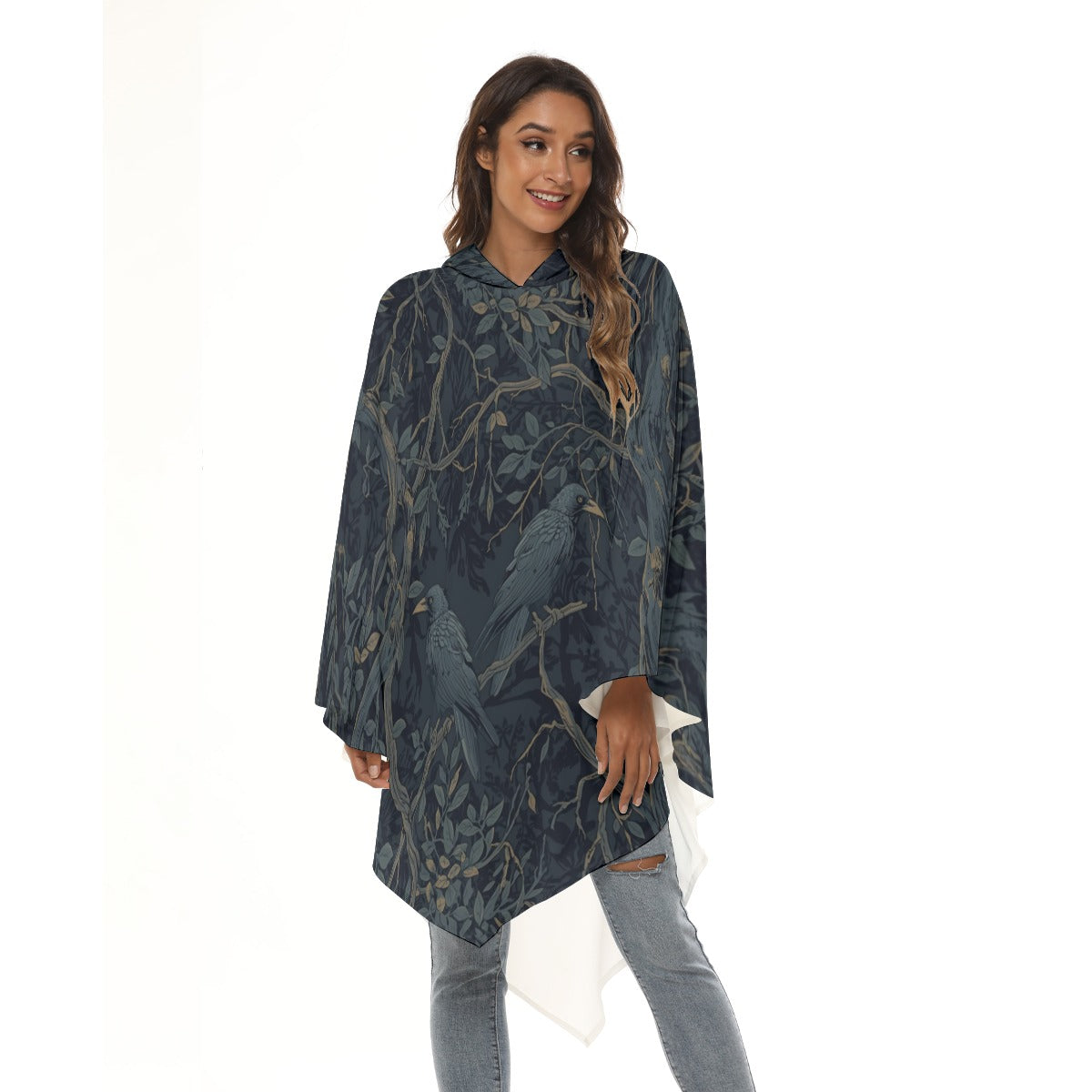 Woman wearing a dark gray poncho with leaf pattern on a white background