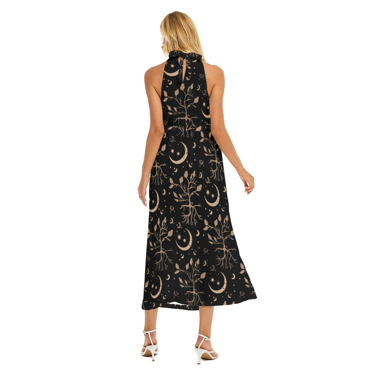 Woman wearing a black dress with celestial pattern on a white background