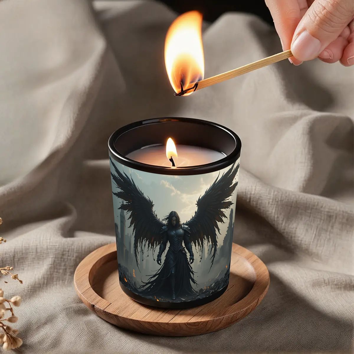 Candle with angel design being lit on a textured surface