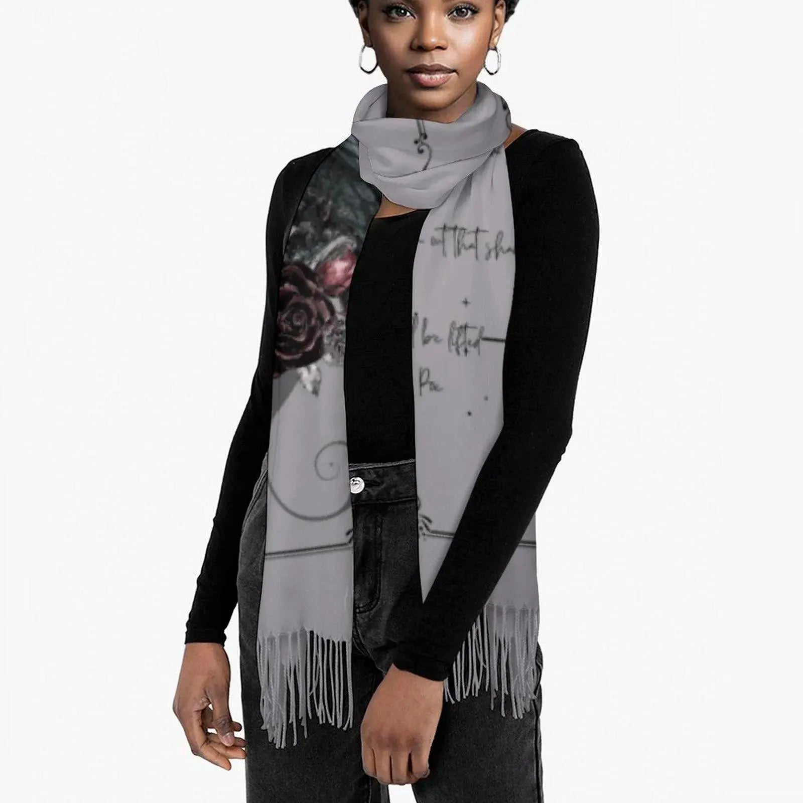 Woman wearing a gray scarf with artistic designs on a white background