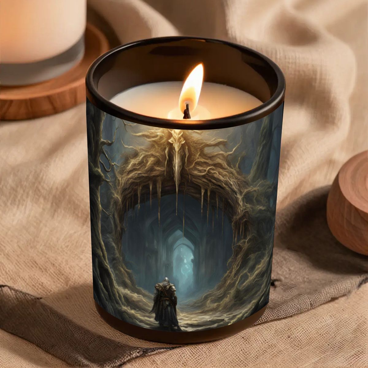 Candle in a decorative glass holder with a fantasy design on a textured surface