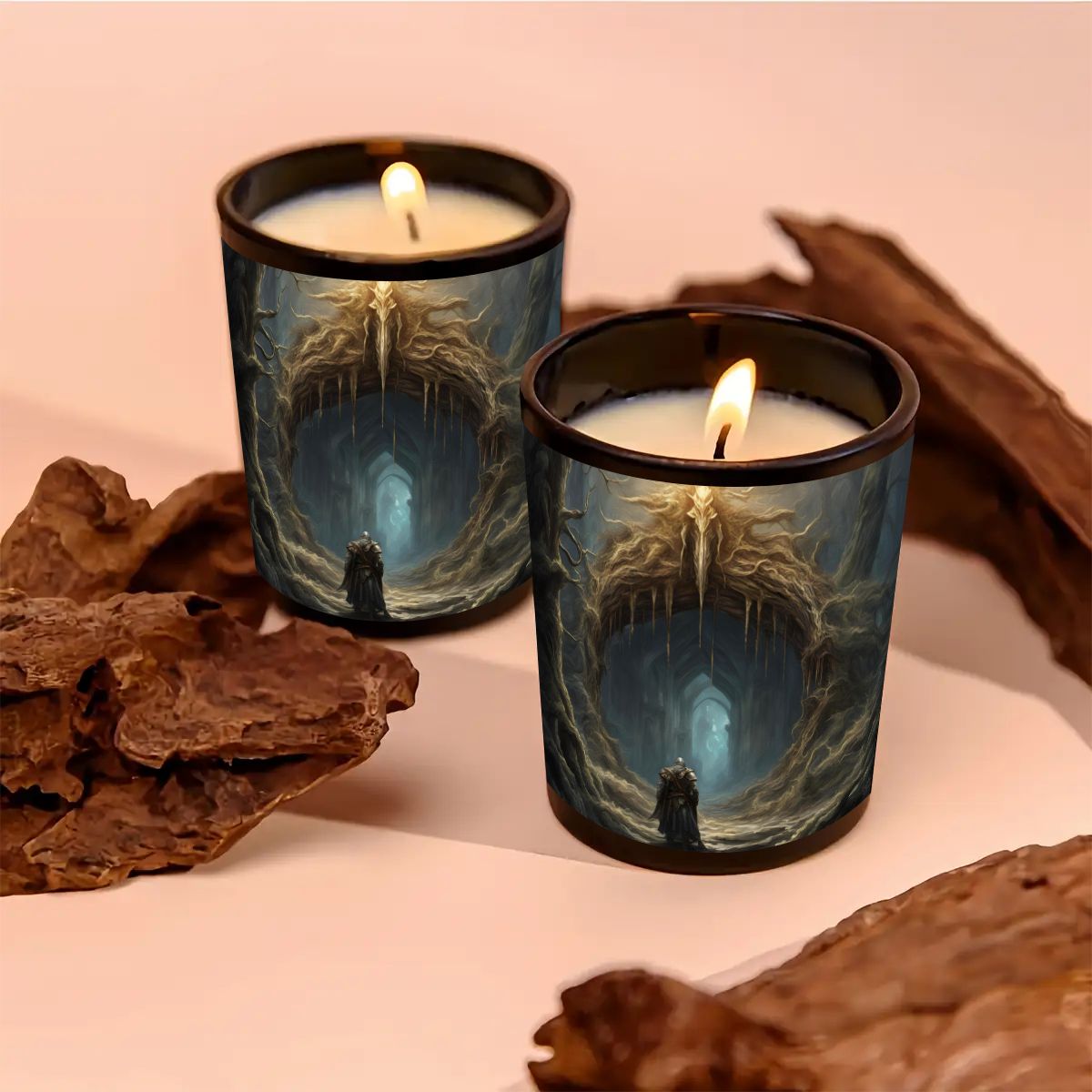 Two lit candles in decorative tins with a fantasy design, surrounded by natural elements on a soft pink background.