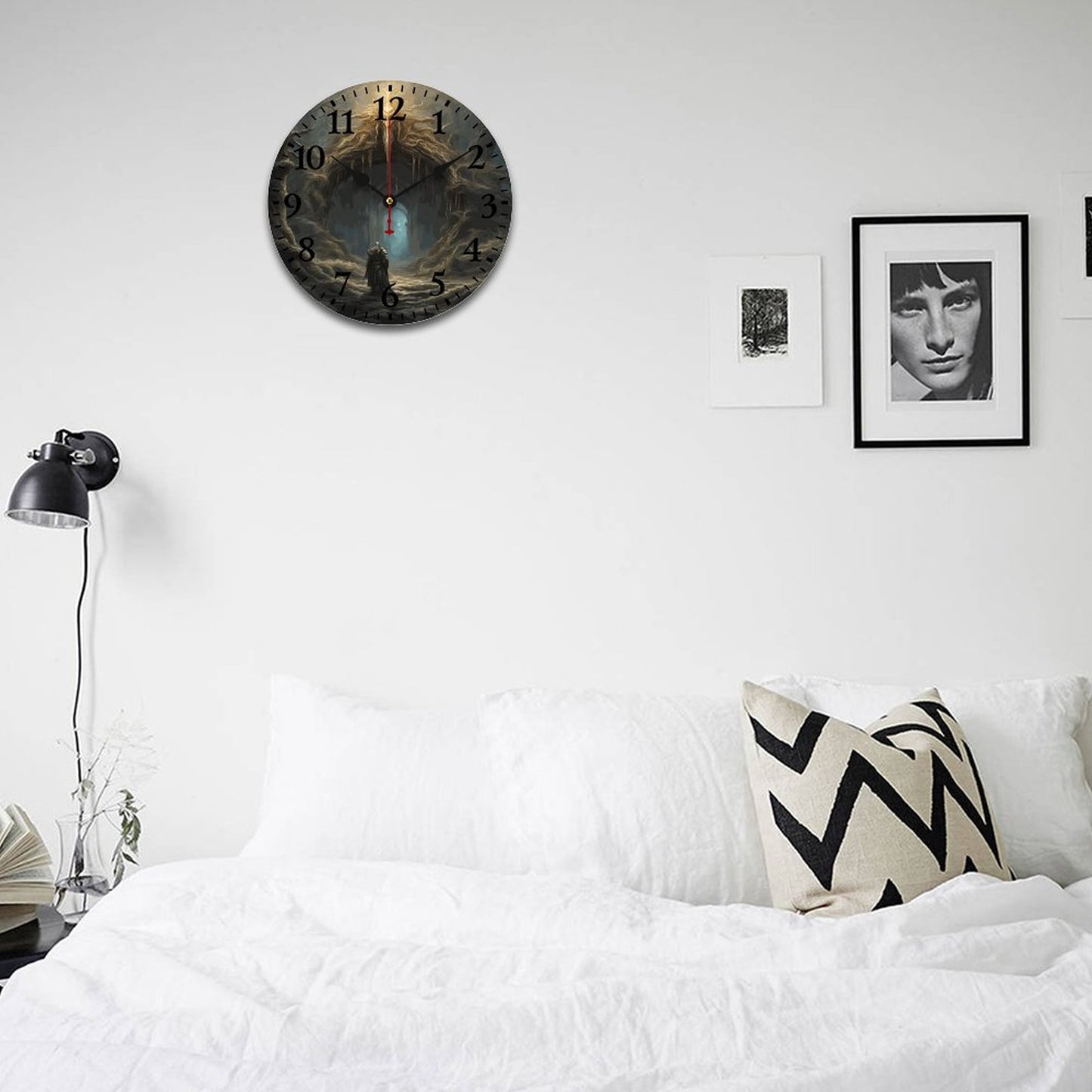 Decorative wall clock on a white wall above a bed with a lamp and framed picture.
