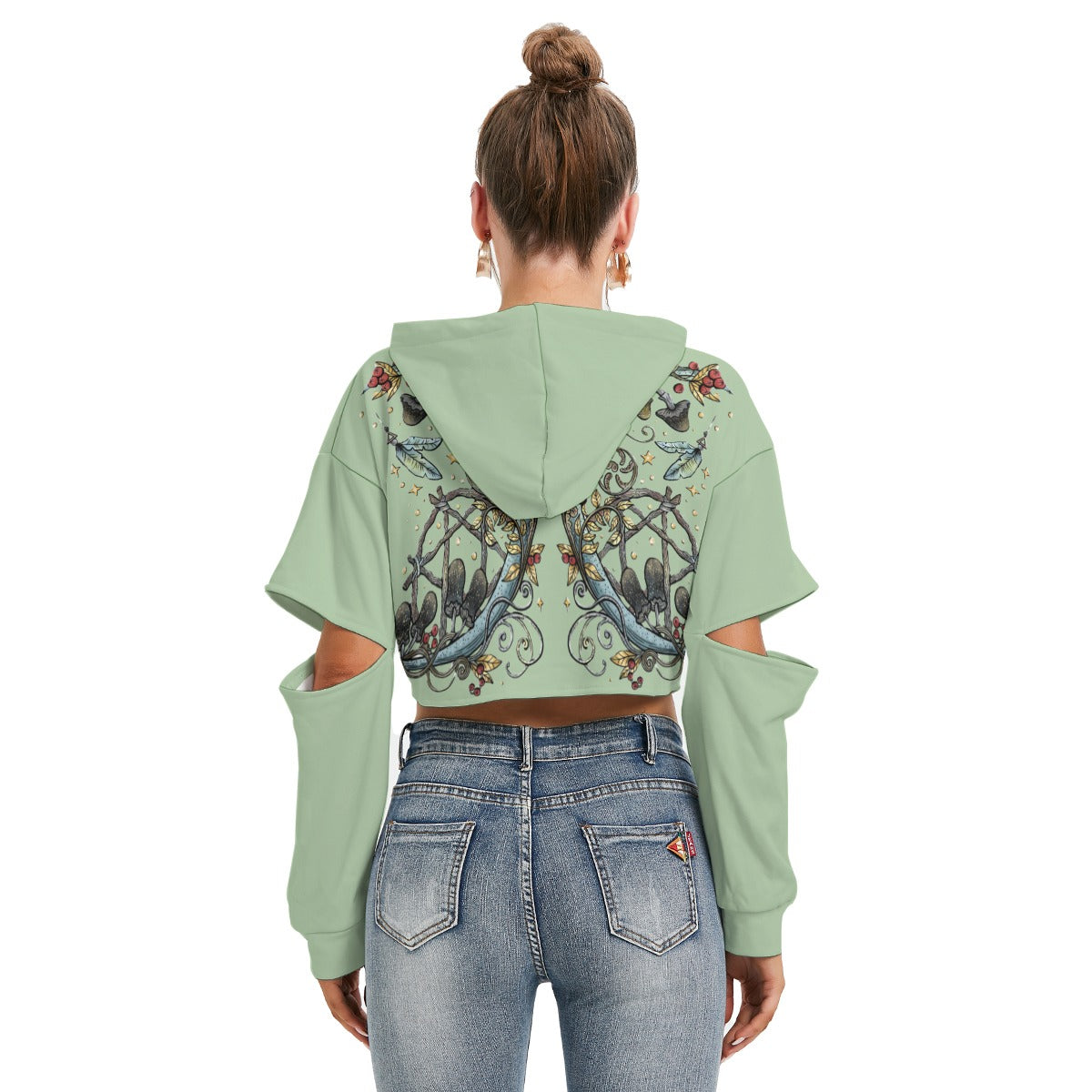 Person wearing a light green hoodie with floral designs and blue jeans on a white background