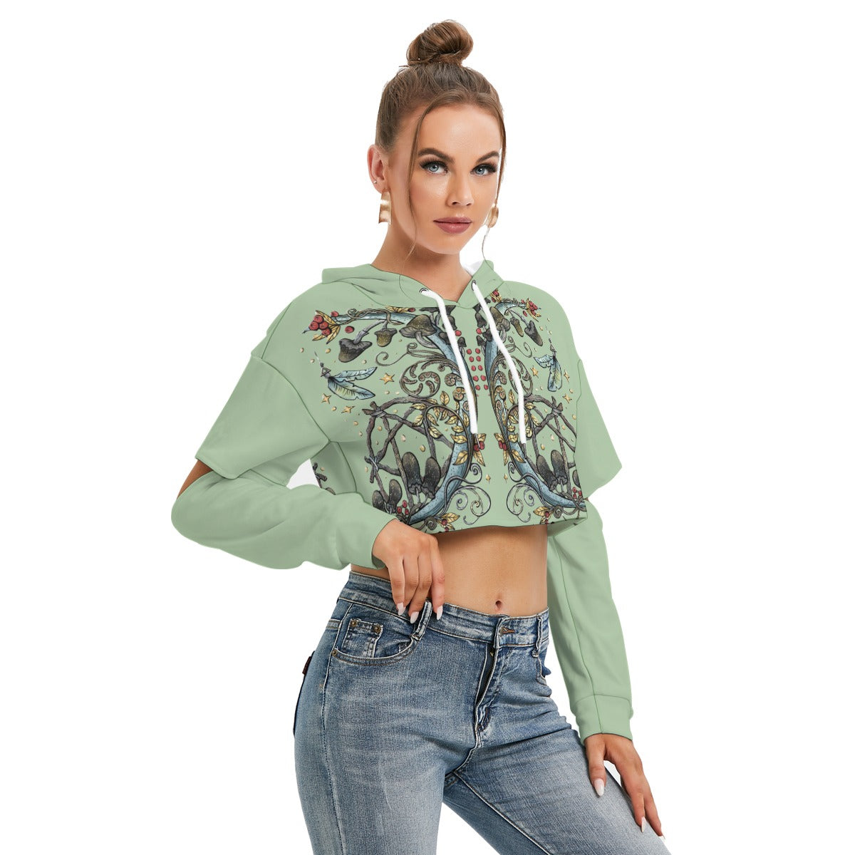 Woman wearing a green hoodie with a graphic design and blue jeans on a white background