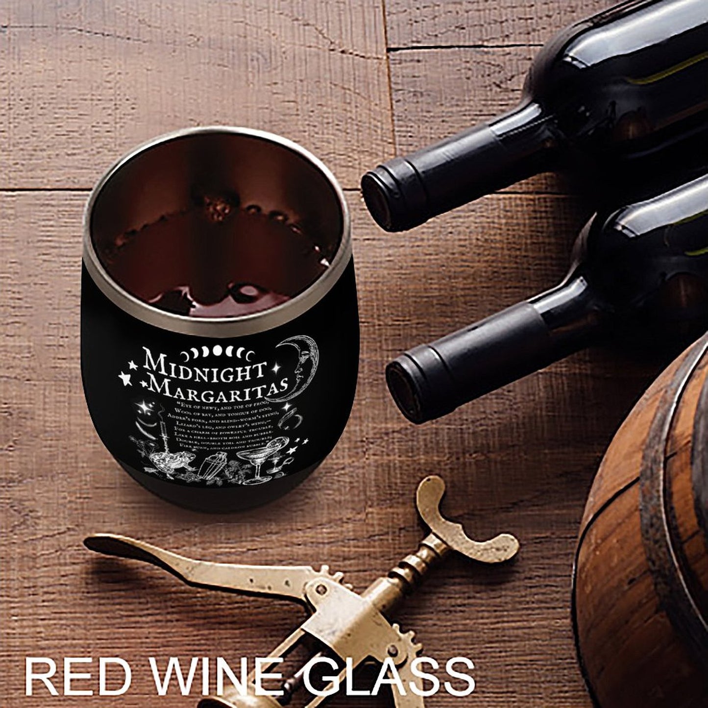 Black wine glass with 'Midnight Margaritas' text on a wooden surface with a bottle and barrel.