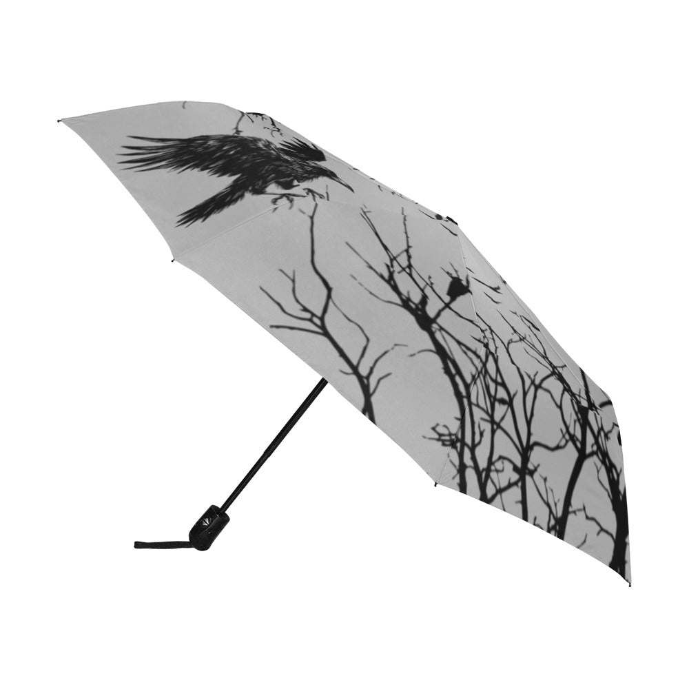 Umbrella with black crow design on a white background