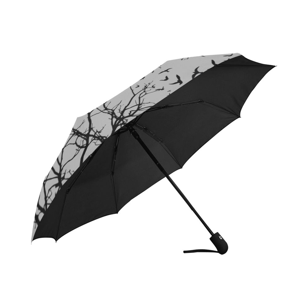 Black umbrella with tree branch pattern on a white background