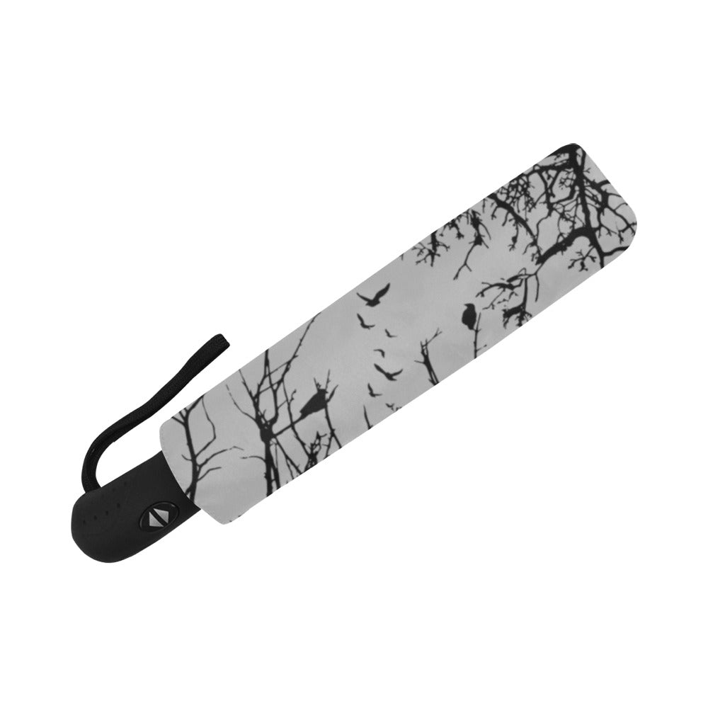 Umbrella with black tree branch pattern on a white background