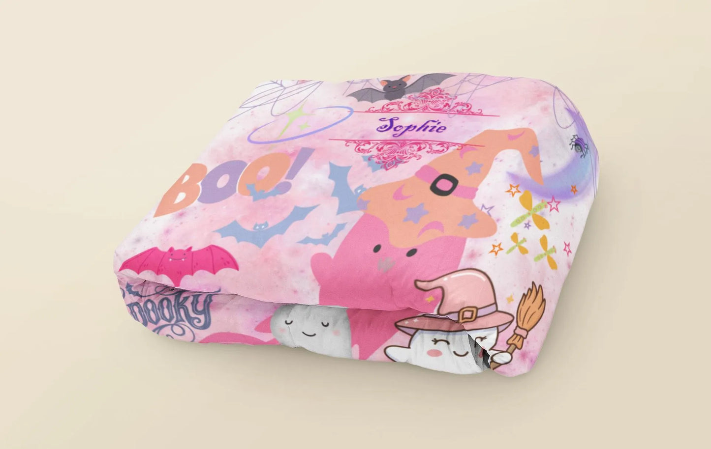 Pink Halloween-themed pillow with cartoon characters on a beige background