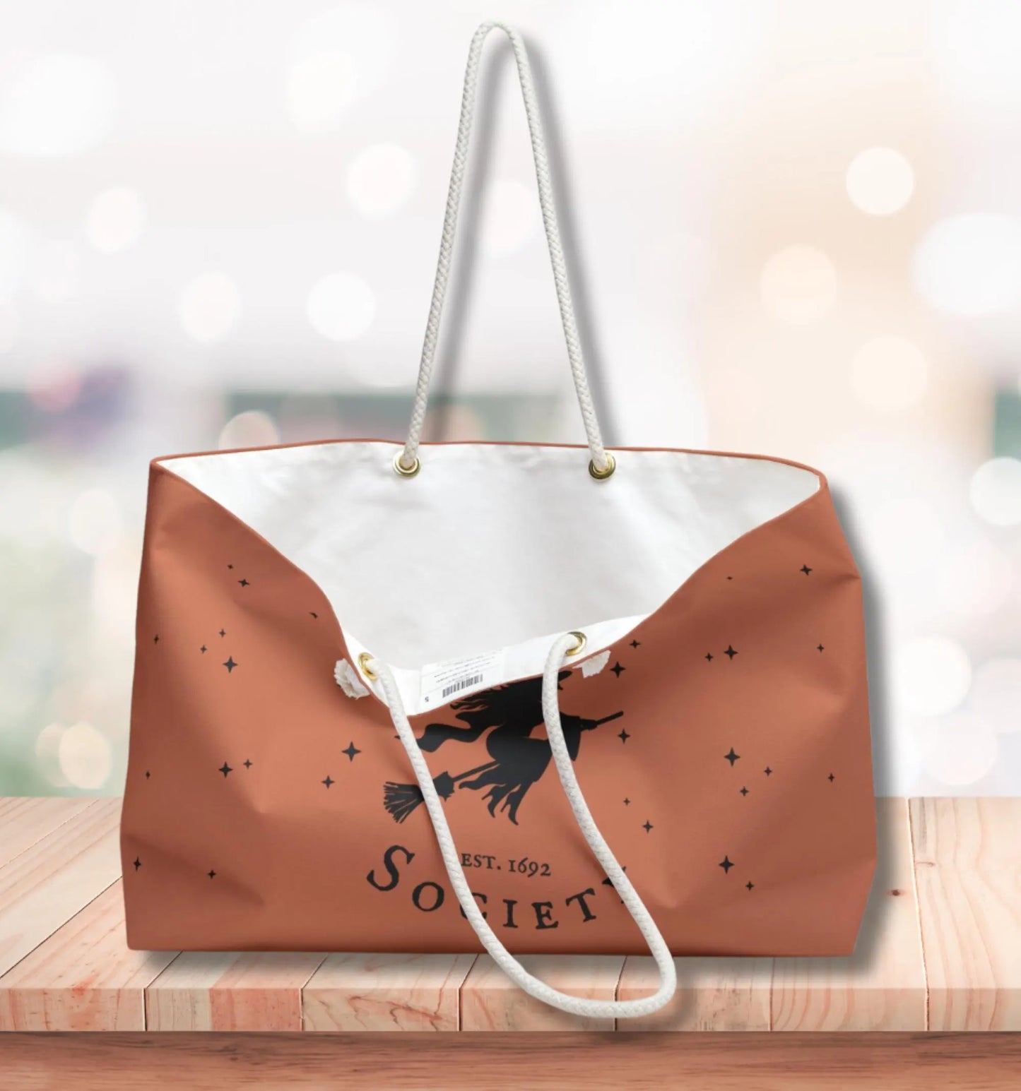 Brown tote bag with white interior and 'Sorbet' branding on a wooden surface.