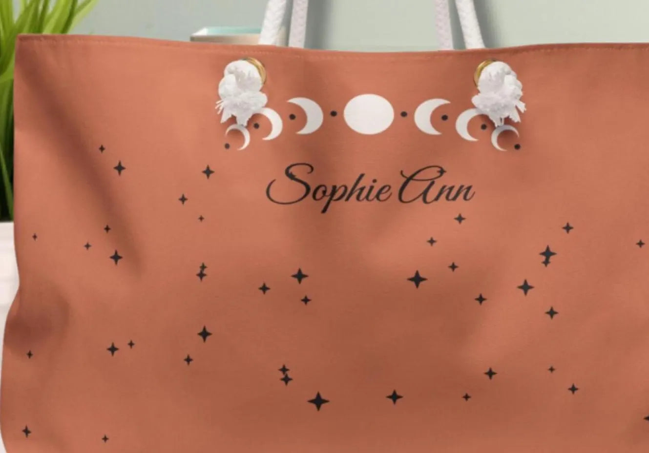 Brown bag with moon phase design and 'Sophie Ann' text