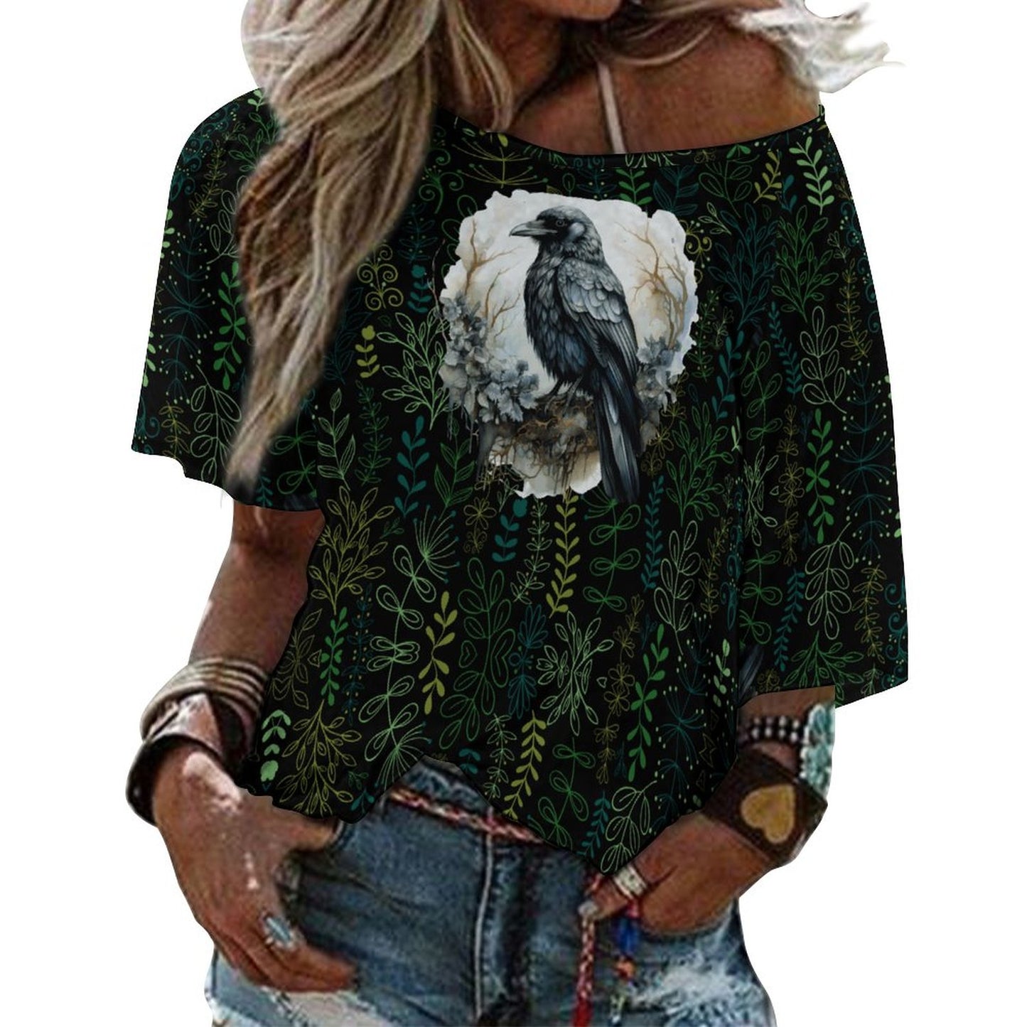 Black t-shirt with bird and floral design worn by a person, with a white background