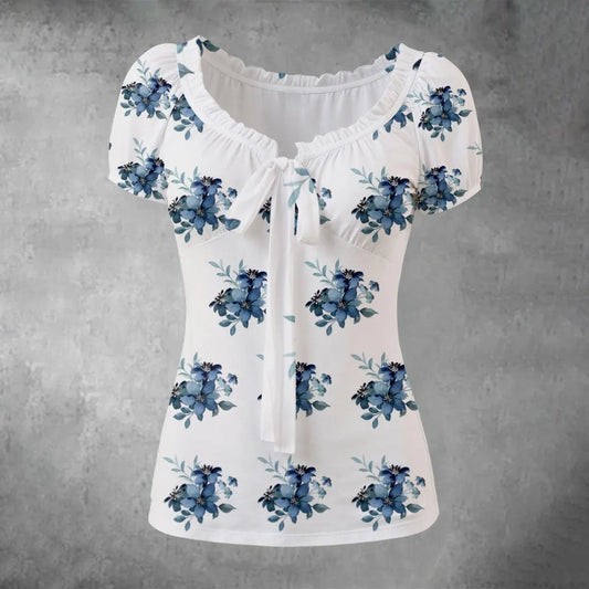 White blouse with blue floral patterns on a gray background