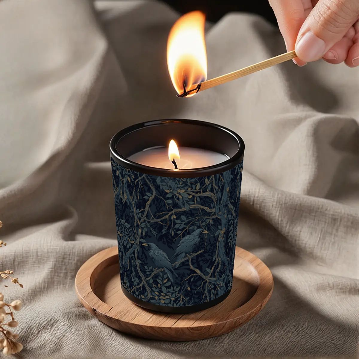 Candle being lit with a match on a textured fabric background