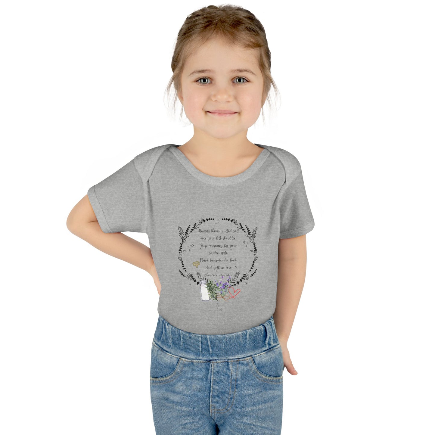 Young girl wearing a gray t-shirt with a design and text on a white background