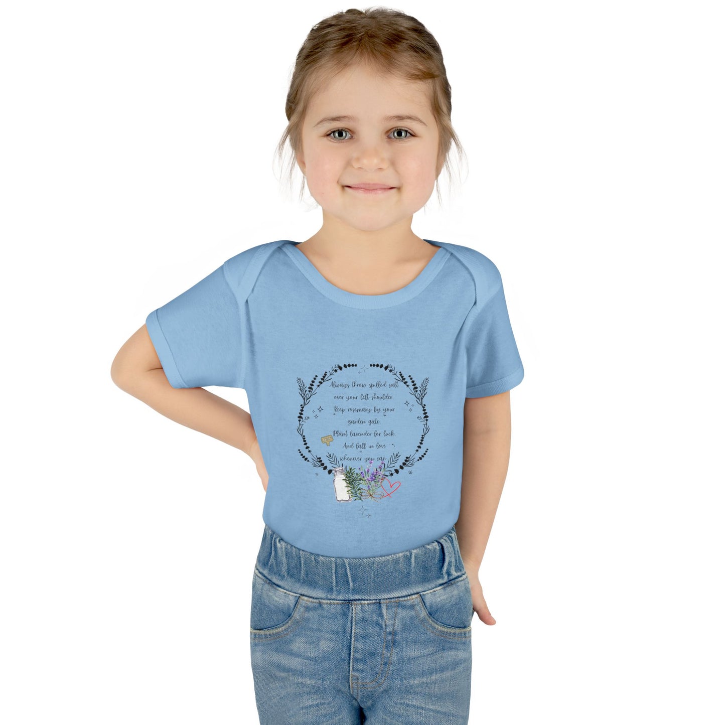 Young girl wearing a blue t-shirt with a design and text on a white background