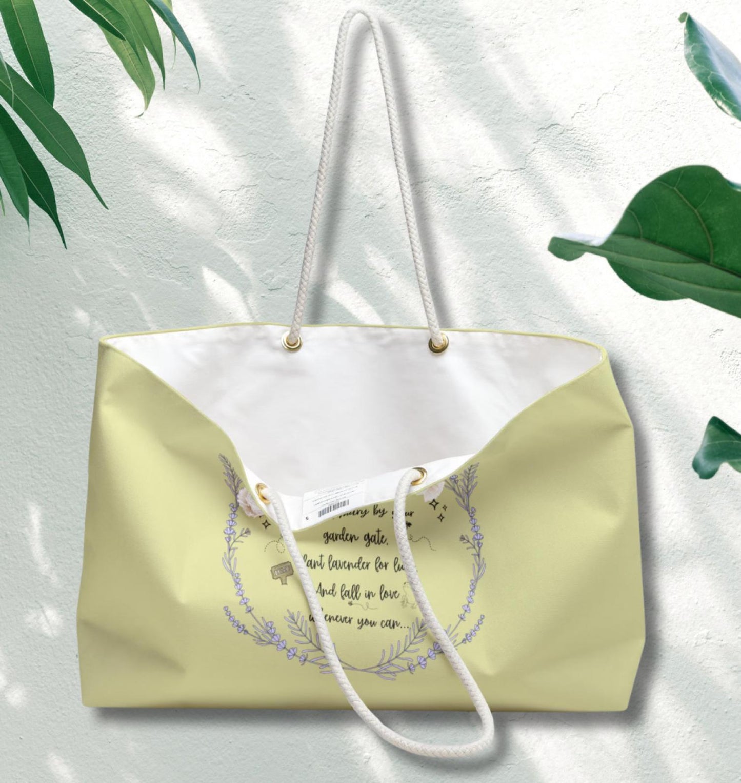 Beige tote bag with white interior and floral design on a light background