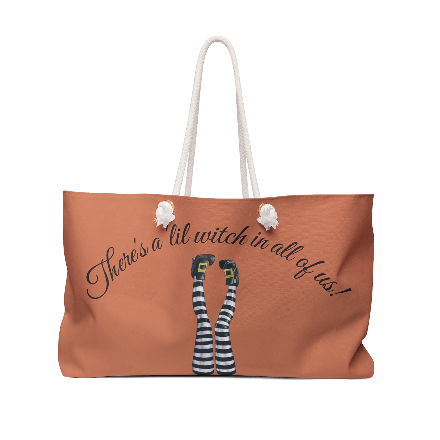 Brown tote bag with witch-themed design and text on a white background