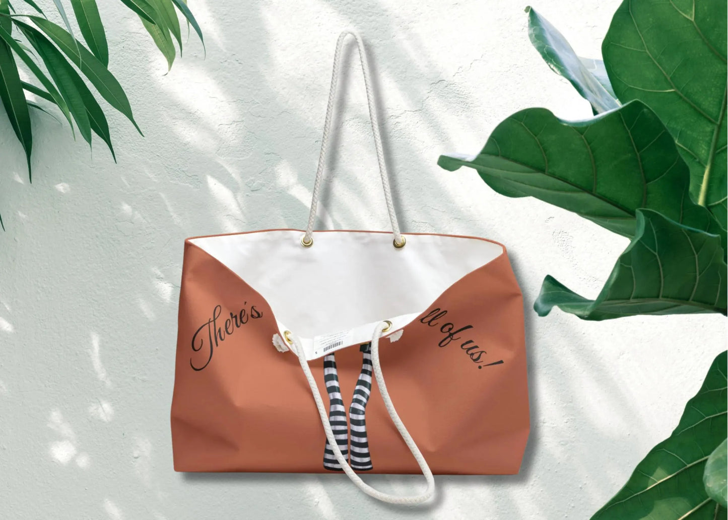 Brown and white tote bag with text on a light background with green leaves