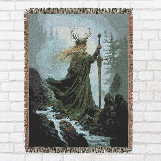 Woven tapestry of a figure in a fantasy setting with a sword and cloak, draped over a brick wall.