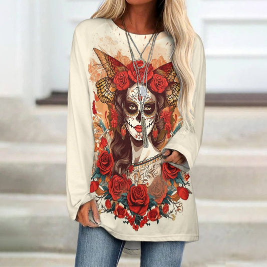 Woman wearing a cream long-sleeve shirt with a colorful skull and floral design.