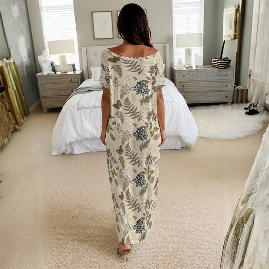 Woman in a floral jumpsuit standing in a bedroom