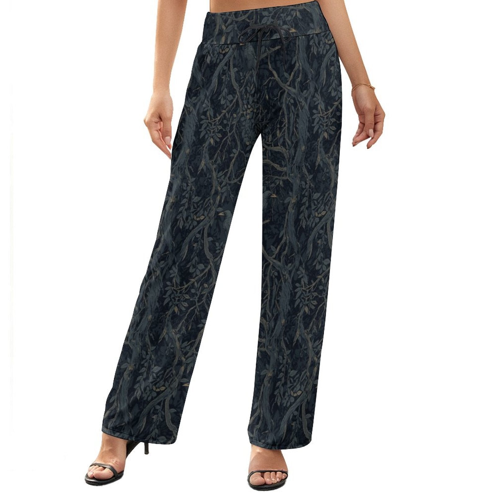 Black floral patterned pants worn by a person on a white background