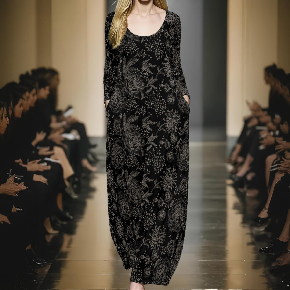 Model wearing a black floral dress on a runway with an audience.