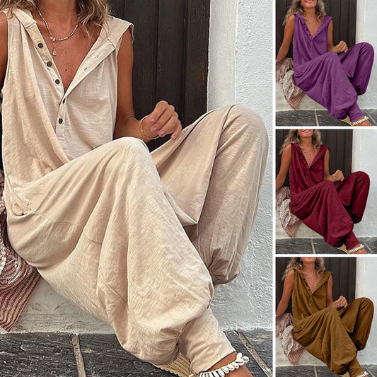 Woman wearing a beige sleeveless Jumpsuit sitting on steps.