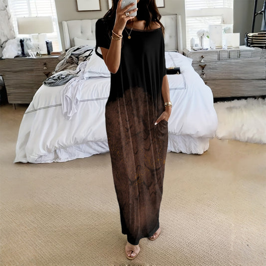 Person wearing a black and brown gradient dress in a bedroom setting.