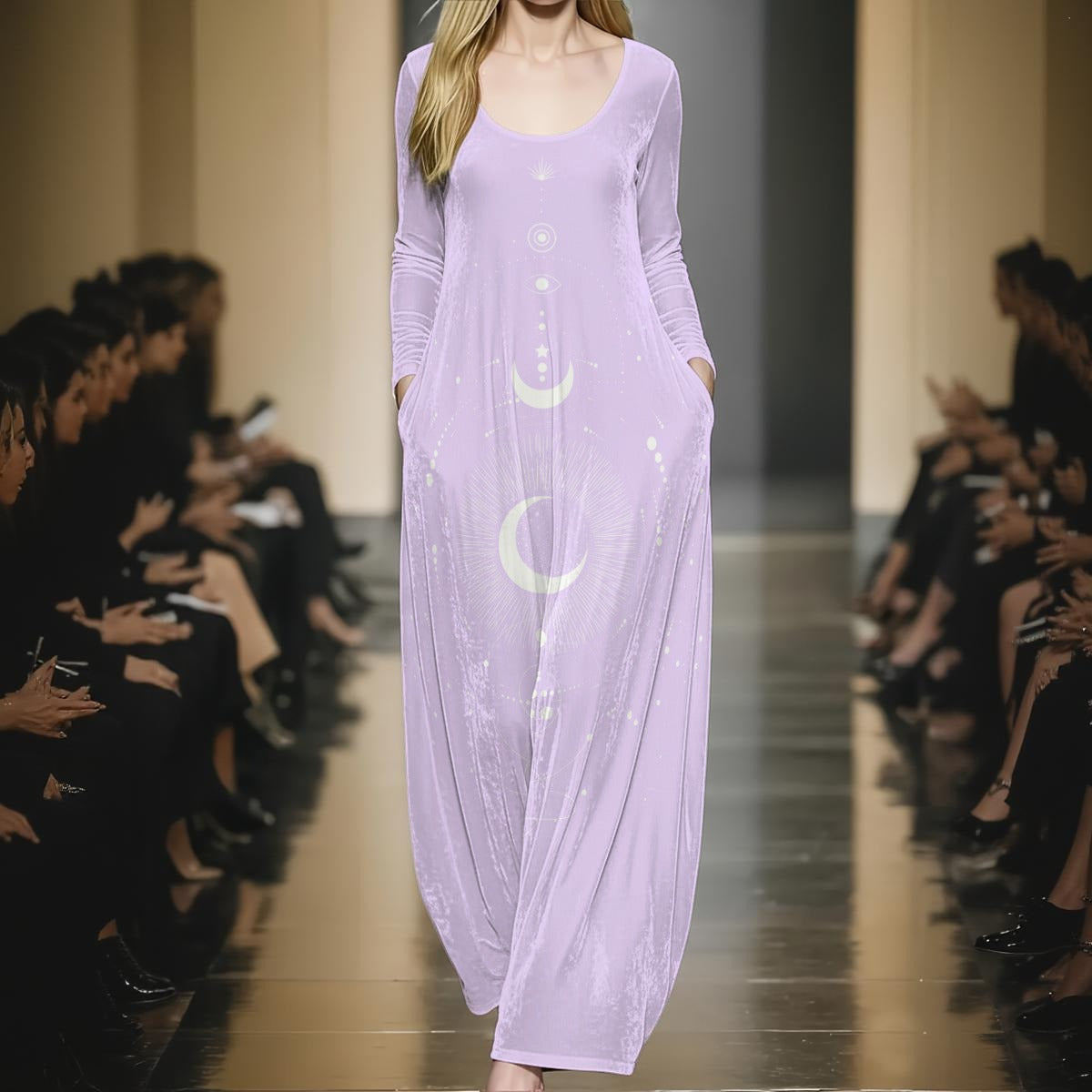 Model wearing a long lavender dress with moon and star designs on a runway.