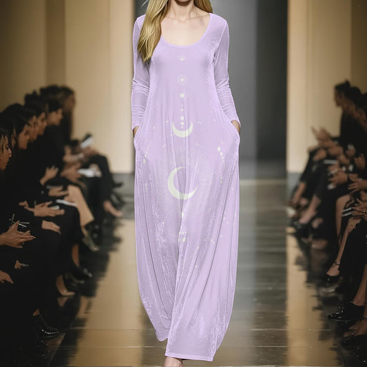 Model wearing a long lavender dress with moon and star designs on a runway.