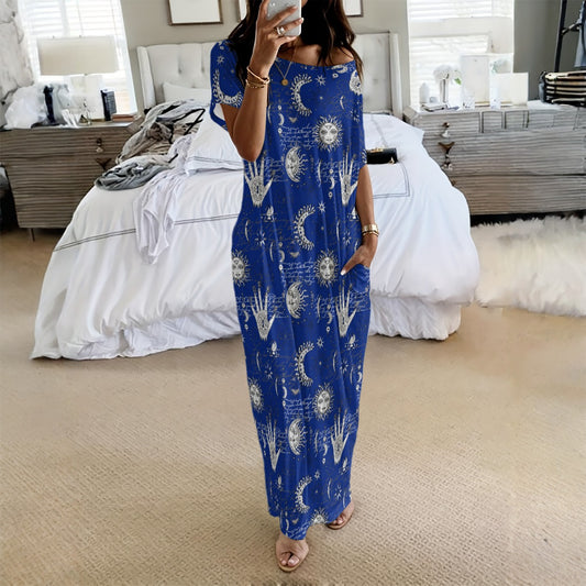 Woman wearing a blue dress with white patterns in a bedroom setting
