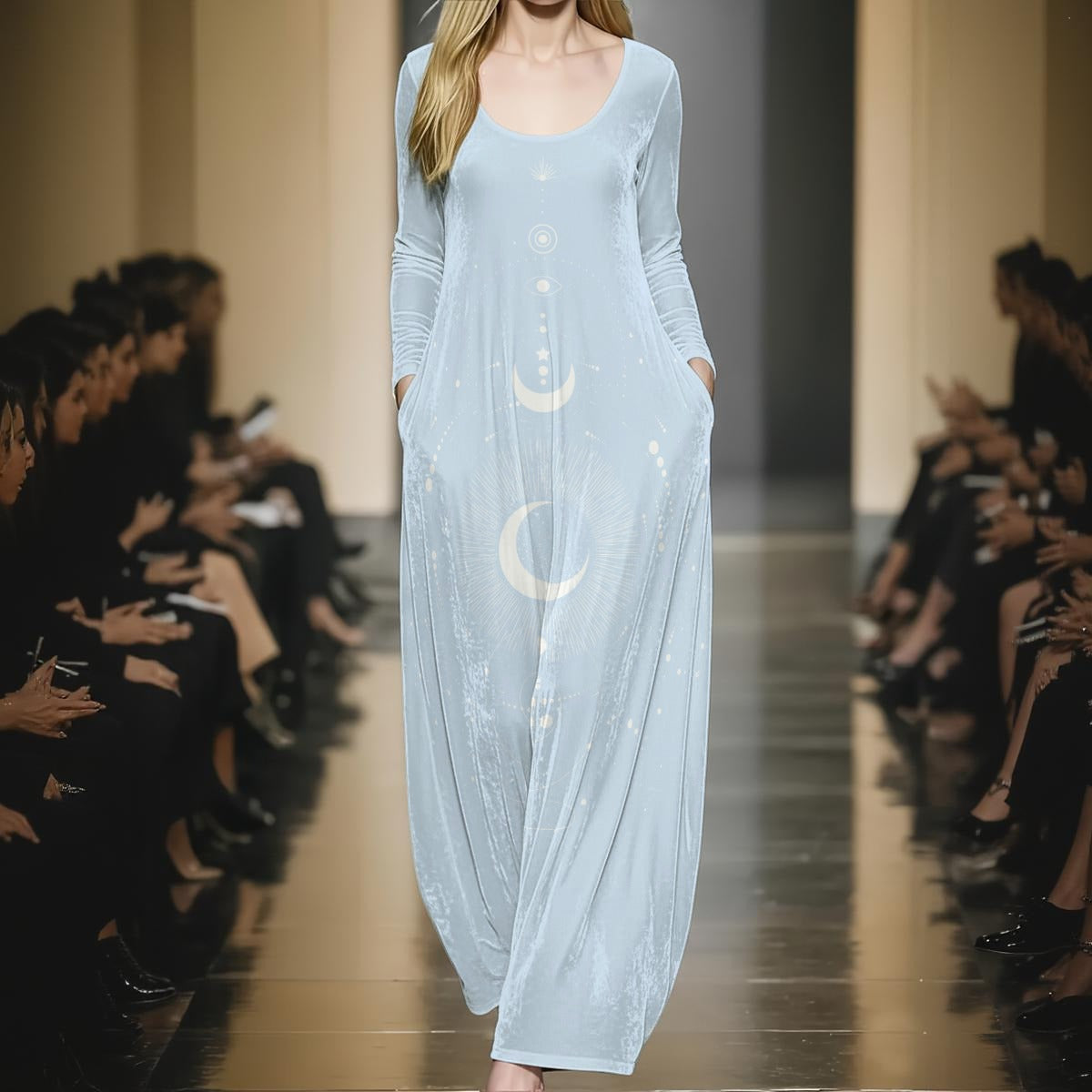 Model wearing a light blue dress with moon designs on a runway.