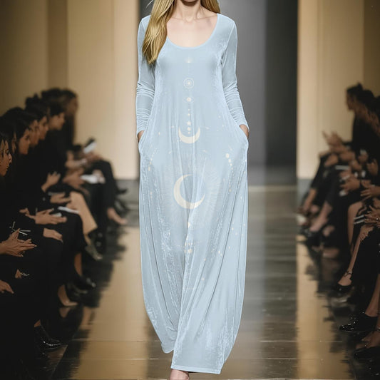Model wearing a light blue dress with moon designs on a runway.