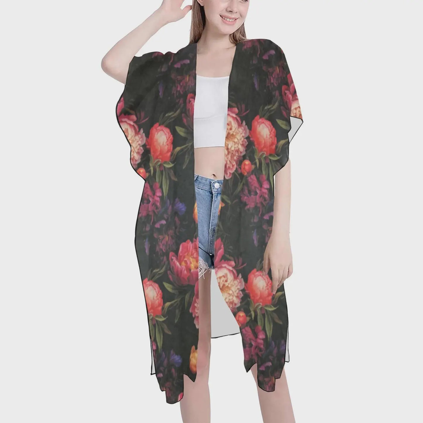 Woman wearing a floral kimono-style garment on a white background
