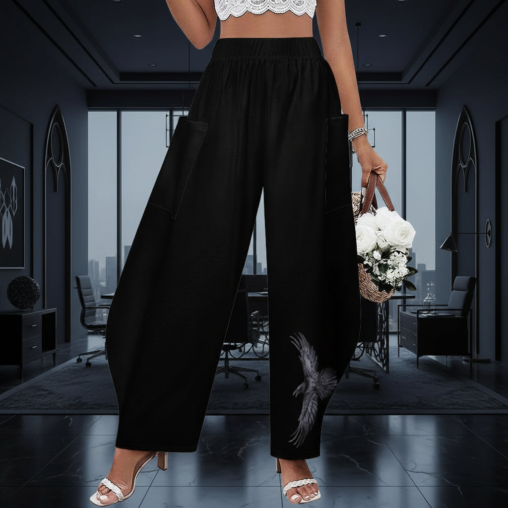 Black wide-leg pants worn by a person in a corporate room