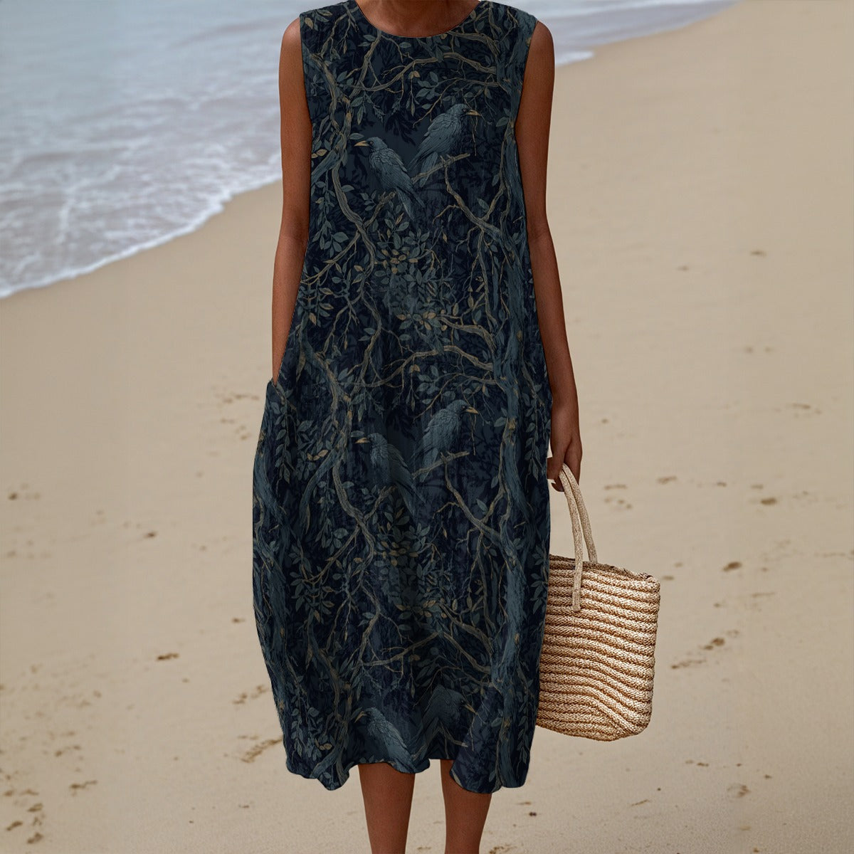 Woman in a dark patterned dress holding a straw bag on a beach.