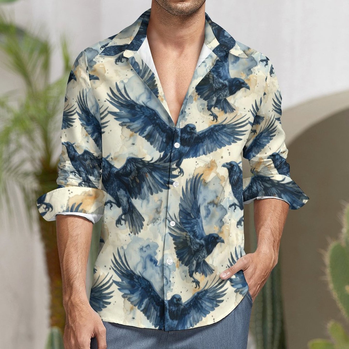 Man wearing a shirt with blue eagle pattern in an outdoor setting