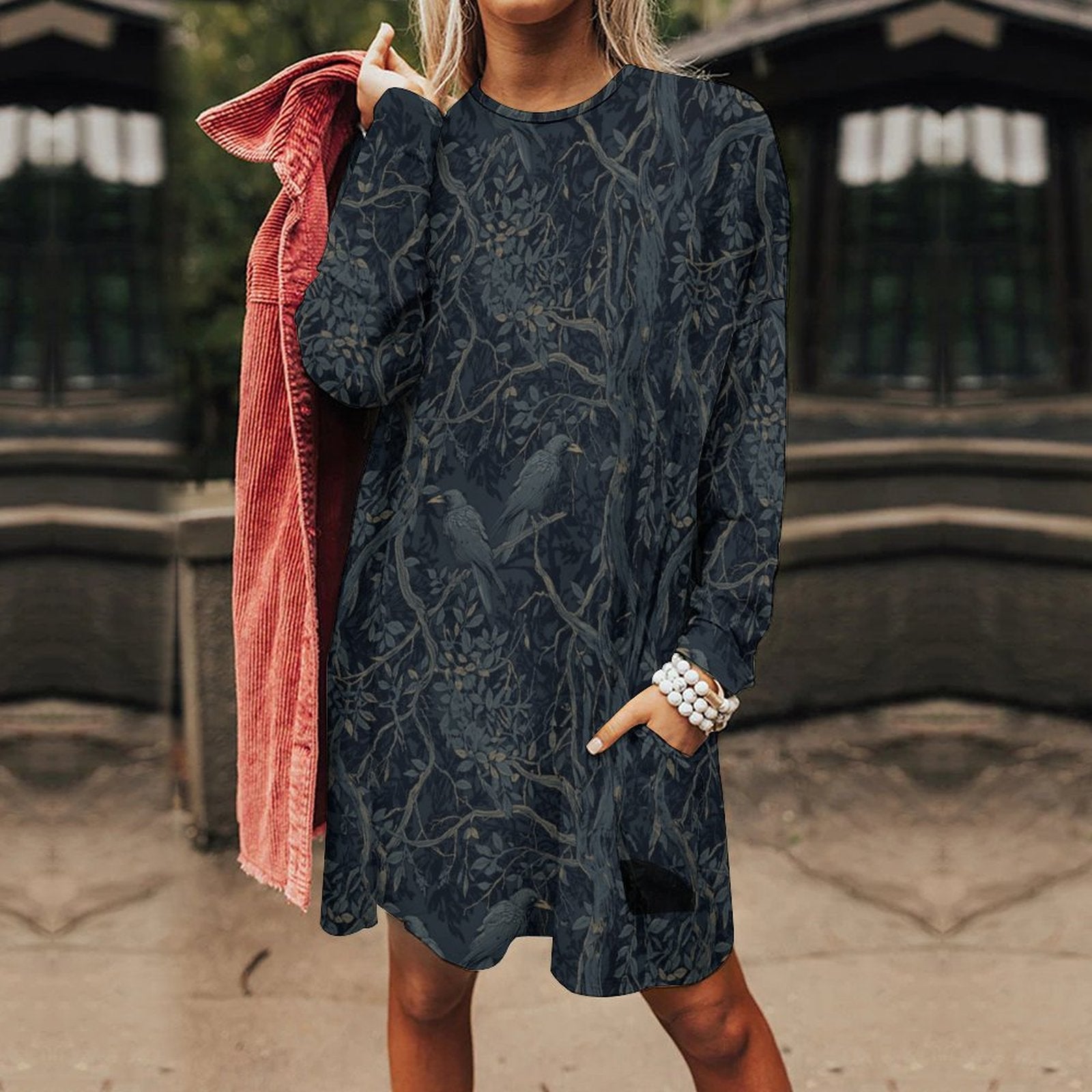 Person wearing a dark patterned dress with a blurred background
