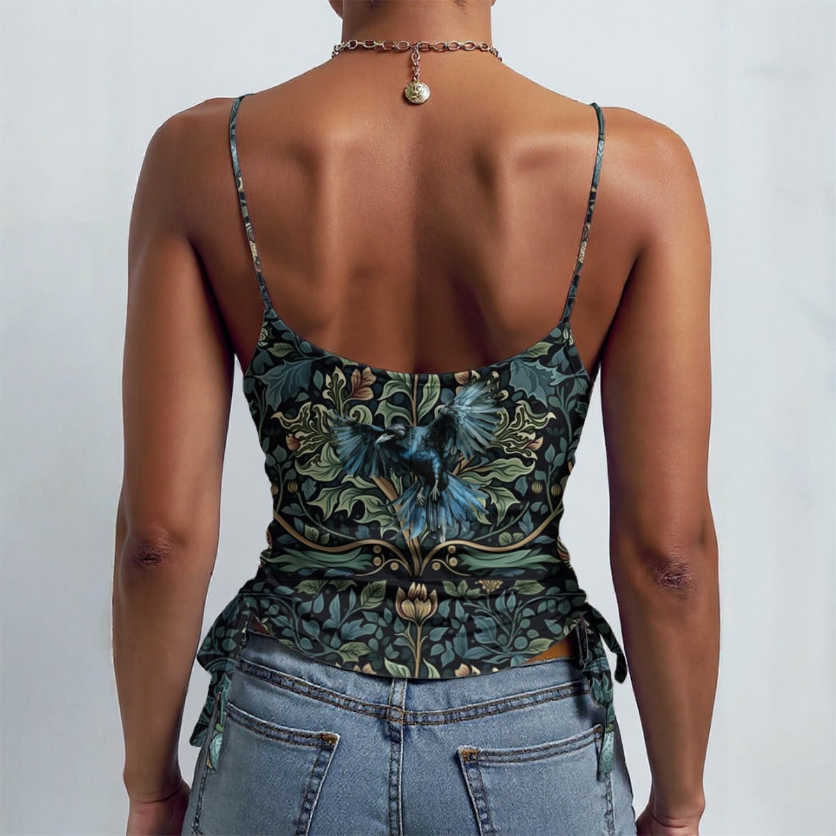 Person wearing a floral top and jeans on a plain background