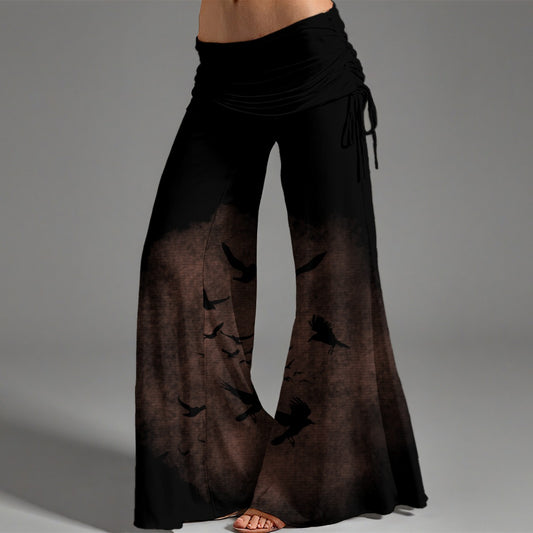 Black and brown gradient pants with bird pattern on a gray background