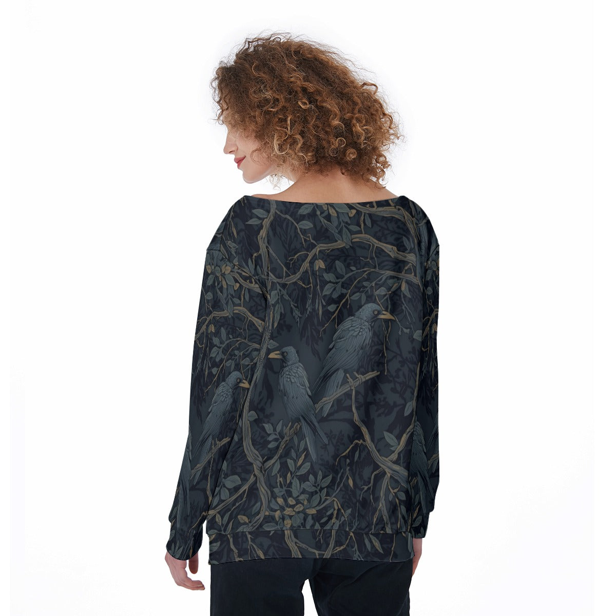 Woman wearing a dark blouse with bird and branch pattern on a white background