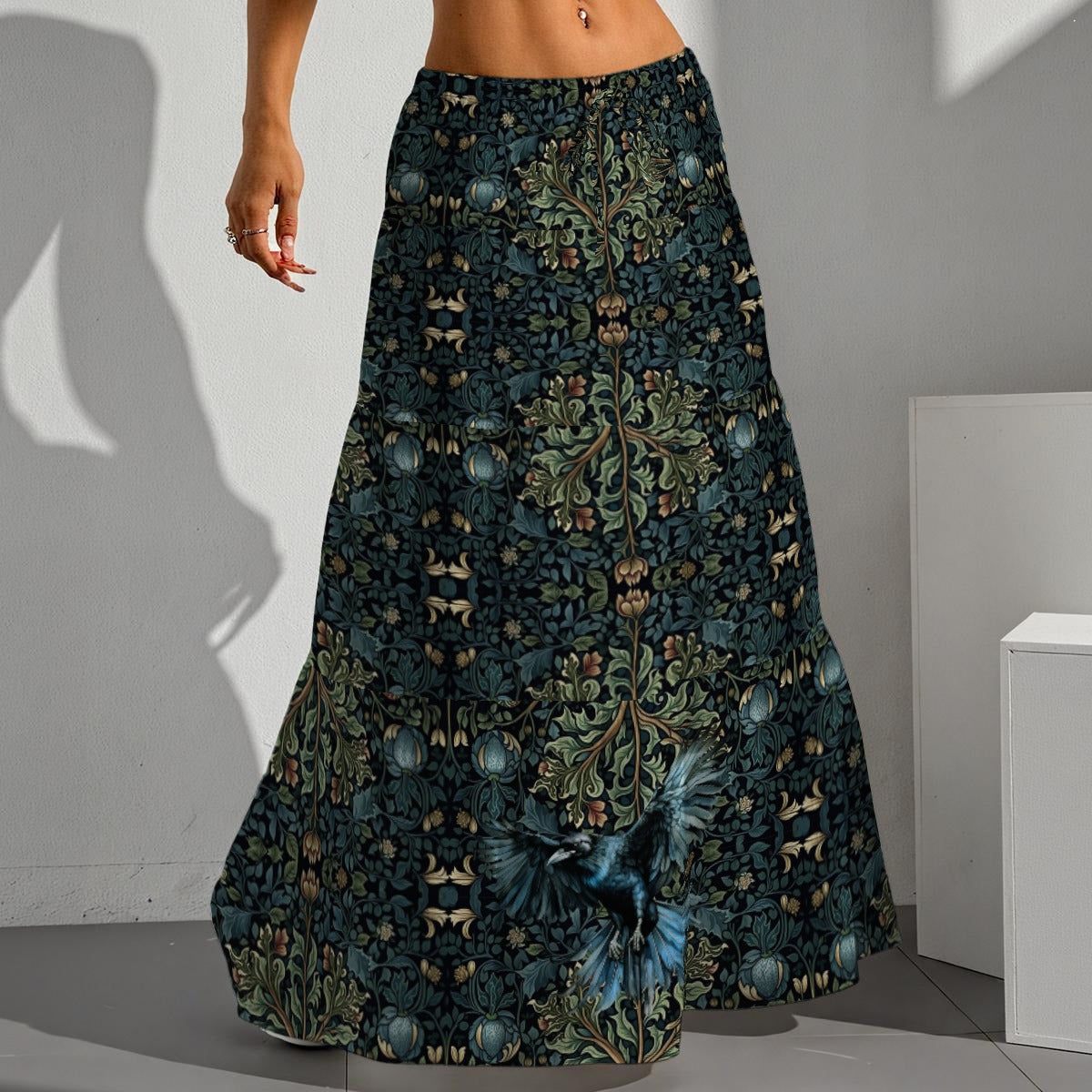 Long patterned skirt with butterfly design worn by a person against a neutral background