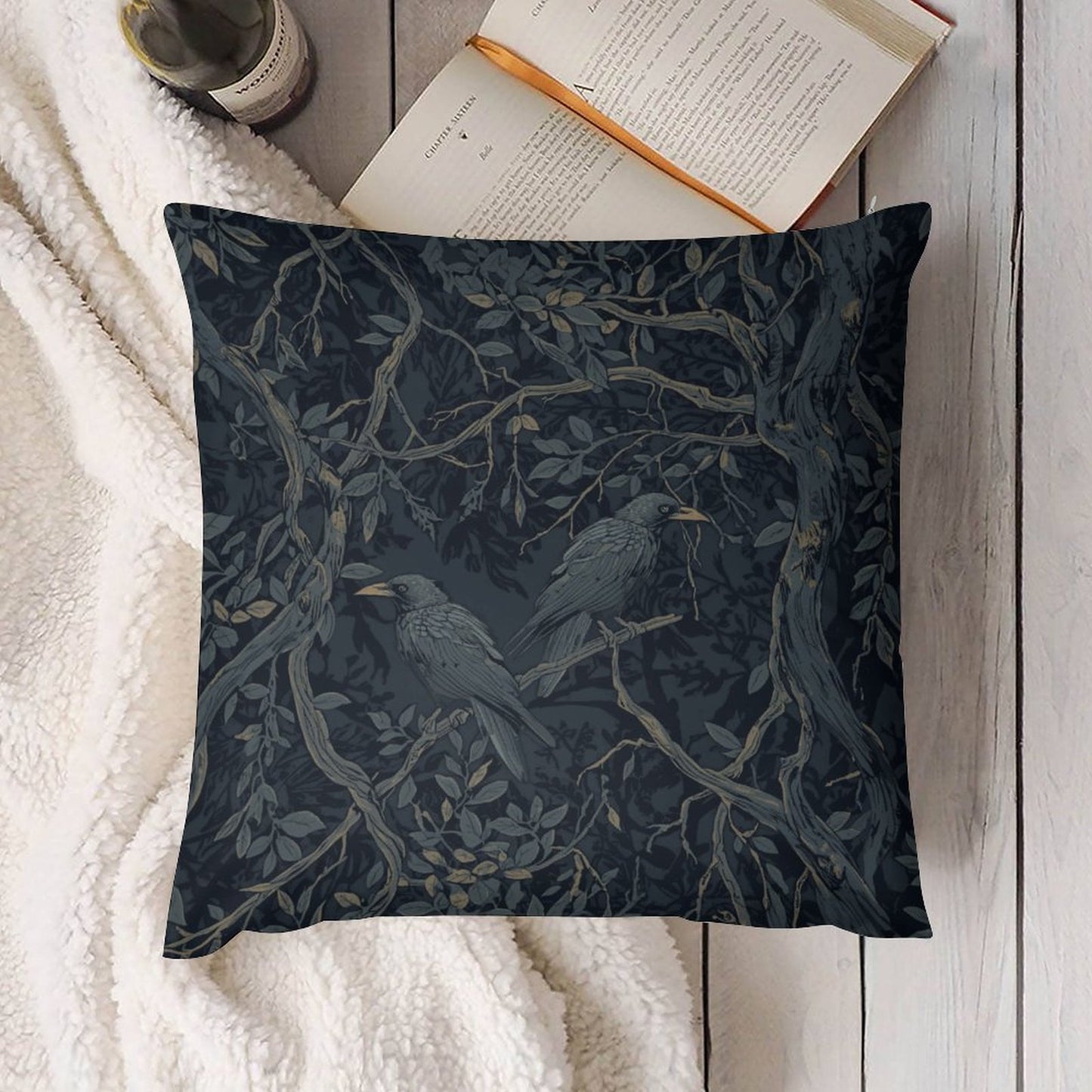 Decorative pillow with bird and branch pattern on a white surface