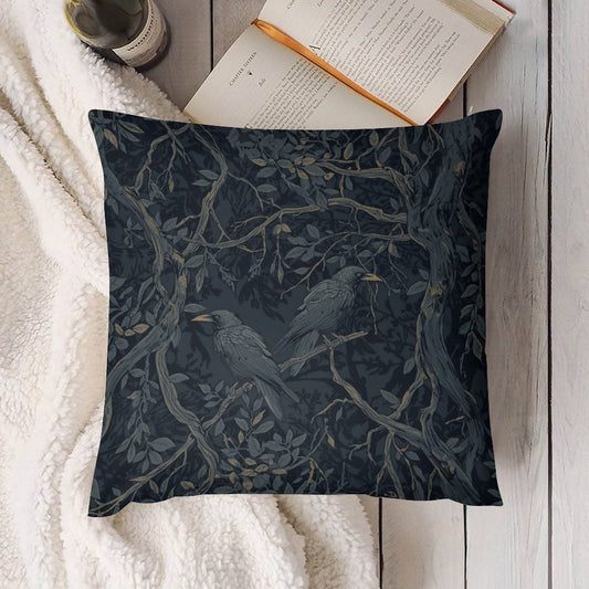 Decorative pillow with bird and branch pattern on a white surface