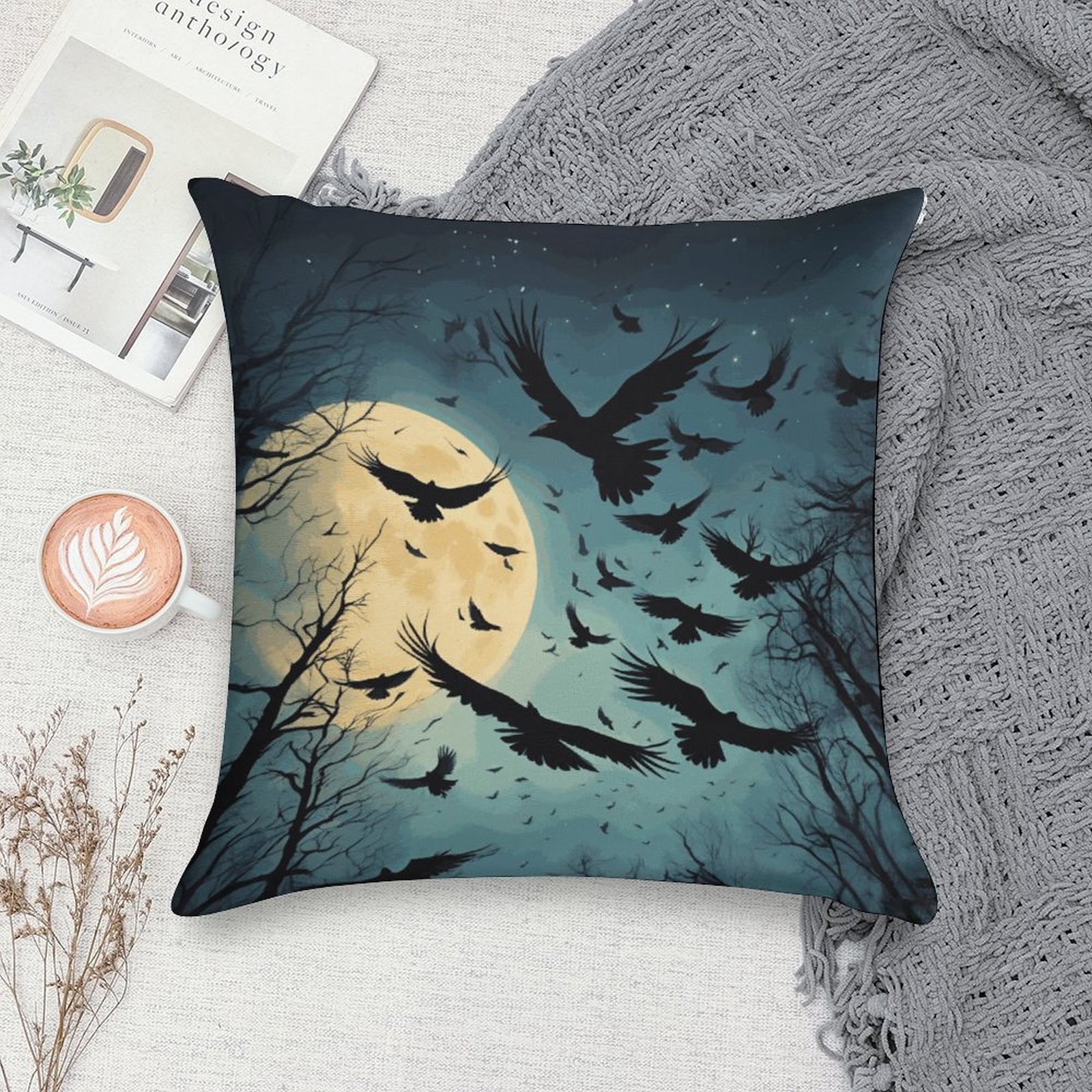 Decorative pillow with a design of crows flying around a moon on a textured surface.