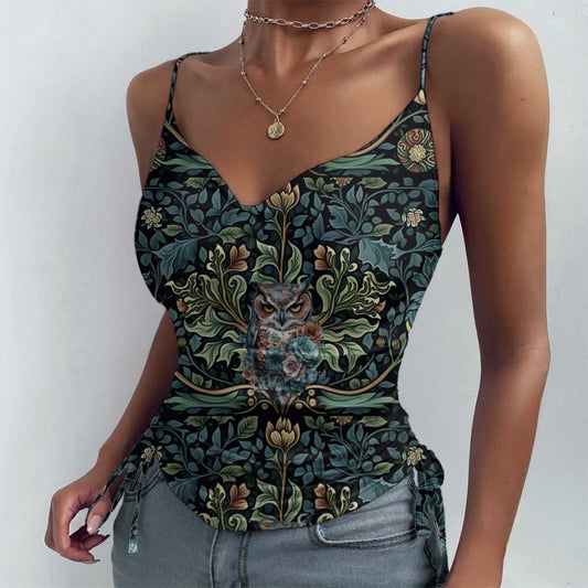 Woman wearing a floral tank top with an owl design on a plain background